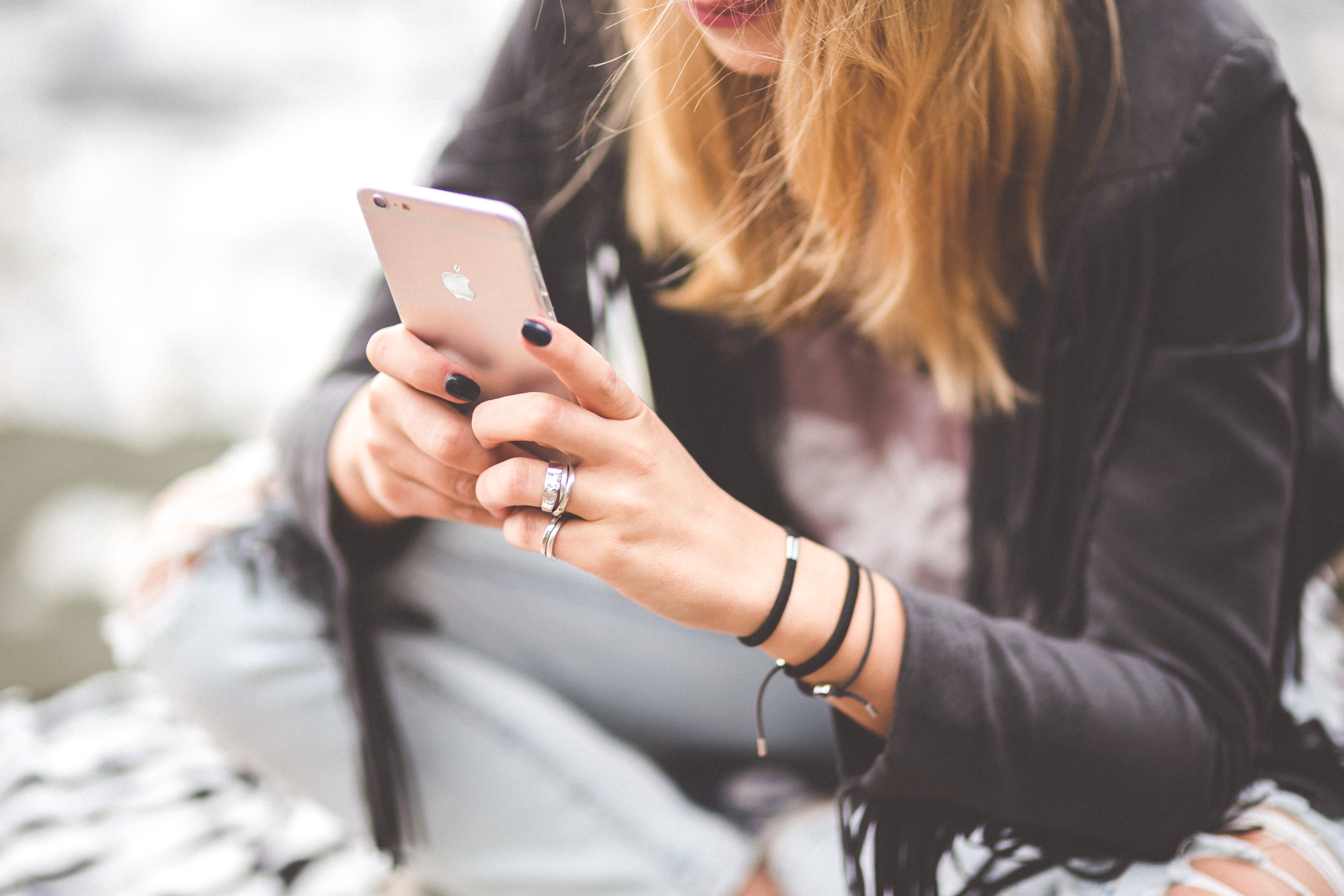 Woman holding a cell phone looking at the screen